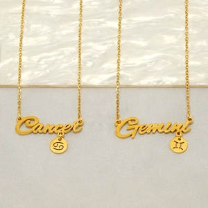Minimalist stainless steel zodiac necklaces with Cancer and Gemini pendants on marble background