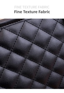 Close-up of fine texture fabric and quilted diamond stitching on large black tote bag