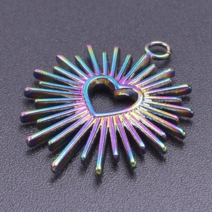 Macro shot of iridescent heart-shaped pendant with sunburst spikes on black texture