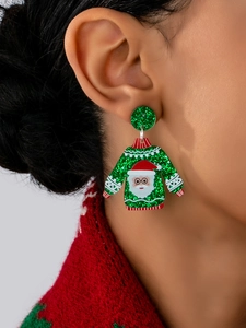 Close-up of sparkling green sequin Christmas sweater earrings with Santa Claus pattern