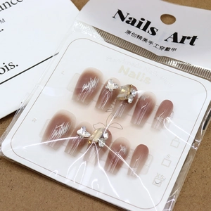 Handmade press-on nails with gradient blush design, 3D butterfly, and sparkling square gems