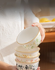 Detail of hand-painted ceramic bowl featuring thick anti-scald base and leaf pattern