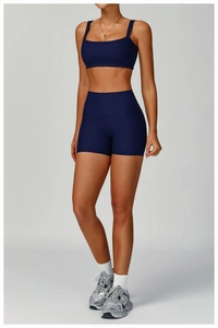 Detail of navy ribbed yoga set showing high-waist shorts and square neck sports bra