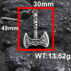 Detailed macro of Viking double axe pendant with eagle wings on dark stone background