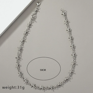 Detail showing thorn-shaped silver necklace with 50CM length and 31g weight specs