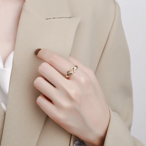 Elegant gold heart gesture ring for couples featuring a creative hand-in-hand design