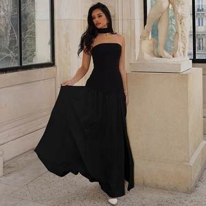 Elegant strapless black slit dress with trailing neck ribbon shown in a classic studio setting