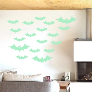Luminous green bat wall stickers for Halloween decor displayed in a modern living room