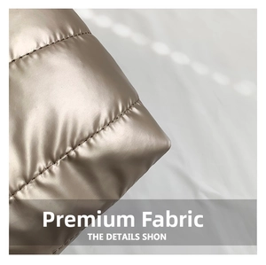Detail view of champagne gold quilted fabric with metallic finish and fine stitching