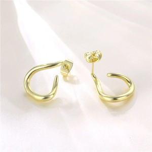 Polished S925 sterling silver golden twisted C-shaped earrings on white silk background