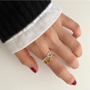 Elegant 925 sterling silver pig nose ring in gold and silver finishes on a hand