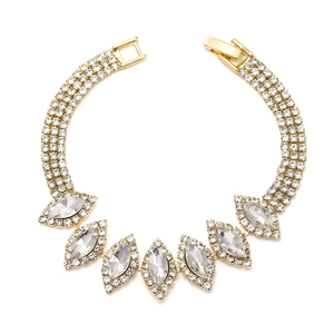 Close-up of sparkling marquise crystal rhinestones on a luxury gold wedding bracelet