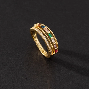 Detail of adjustable gold ring with colorful rectangular gems and micro-paved diamonds