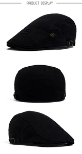 Detail of black cotton flat cap with letter embroidery and adjustable metal buckle