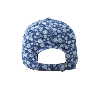 Detail view of denim floral baseball cap with metal buckle and adjustable back strap