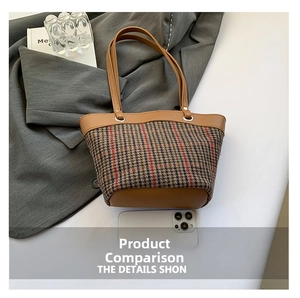 Detail view of large plaid tote bag showing its capacity compared to a smartphone
