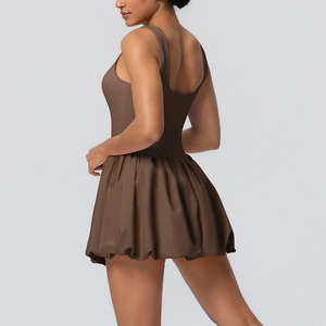 Detail view of the coffee brown backless tennis dress with flare hem and wide straps