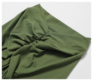 Detailed close-up of scrunch butt seam on high-waist green yoga leggings showing texture