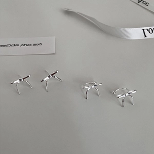 Elegant silver bow stud earrings and ear cuff set with a minimalist metallic finish
