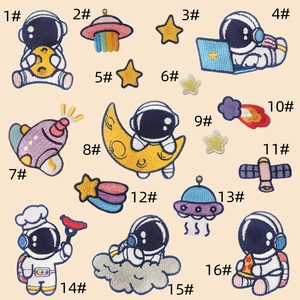 Macro detail of various space-themed embroidery patches including astronauts and stars