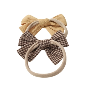 Set of two soft stretchy baby headbands in solid beige and brown checkered patterns