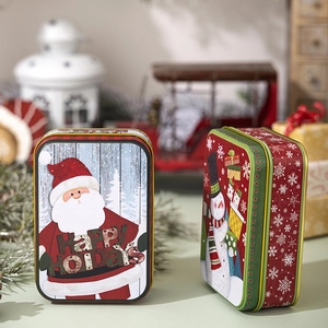 Detailed view of Christmas tin boxes featuring Santa Claus and snowman festive designs