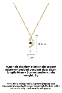 Detail of gold star and moon pendant with blue center stone and pave zircon on titanium chain