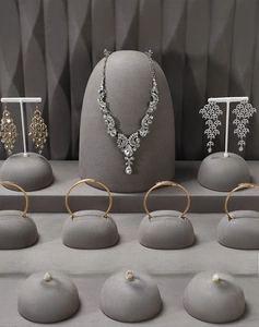 Detailed view of dark grey velvet jewelry display set featuring necklace and earring stands