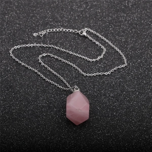 Detail of pink crystal hexagon perfume bottle pendant with silver chain necklace