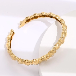 Minimalist gold-plated geometric beaded open bangle with matte texture and faceted design