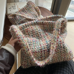Close-up of colorful tweed woven tote bag showing multi-color texture and soft knit finish