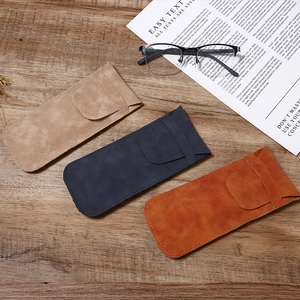 Premium soft leather sunglasses pouches in beige, navy, and caramel on a wooden surface