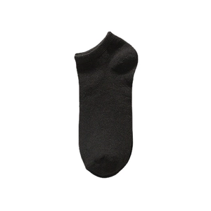 Minimalist black disposable low cut cotton ankle socks for travel on white background