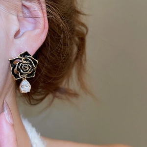 Macro view of 18k gold plated vintage rose earrings with droplet zircon gemstone
