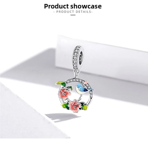 Detail showing enamel bird and flower charm with zircon inlays in 925 sterling silver