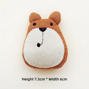 Close-up of a handmade knitted brown bear patch showing texture, 7.5cm by 6cm size