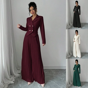 Detail of elegant two-piece suit with double-breasted blazer and pleated wide-leg pants