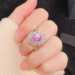 Macro shot of luxury ring with large oval pink gemstone and brilliant white diamonds