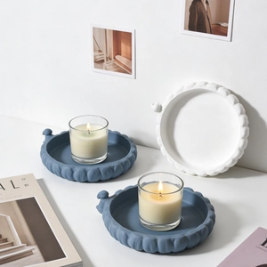 Round matte ceramic tray with scalloped edges and bird handle for home decor