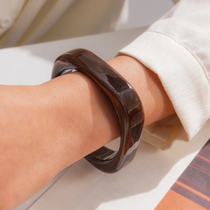 Chic brown marbled resin square bangle worn on wrist, minimalist jewelry style