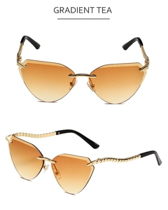 Detail of rimless cat-eye sunglasses with gradient tea lenses and wavy gold metal temples