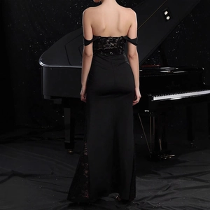 Detailed back view of off-shoulder evening dress with exquisite black floral lace paneling