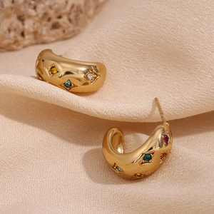 Detailed macro shot of vintage 18K gold plated C-shape earrings with colorful zircons
