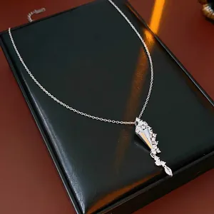 Elegant silver hourglass pendant necklace with marquise zircons on a black leather display