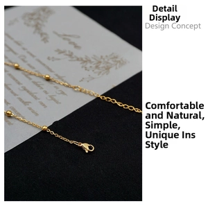 Close-up of golden titanium steel bead chain necklace with a secure lobster clasp