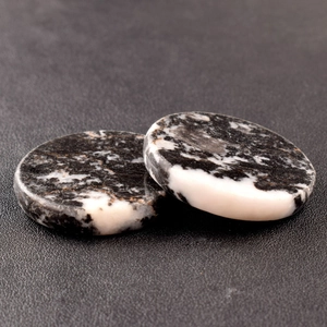 Detailed view of polished 40x8mm round natural stone disks with black and white marble patterns