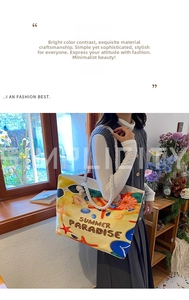Detail of yellow canvas tote bag with starfish print and white cotton rope handle
