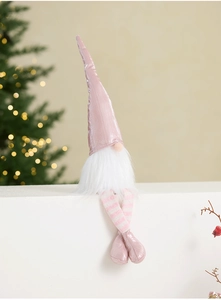 Pink plush Christmas gnome with telescopic legs sitting on white steps near a tree