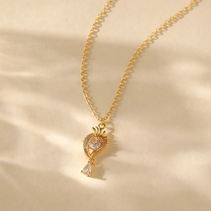 Detailed view of an 18K gold-plated fan pendant with zircons on a delicate chain