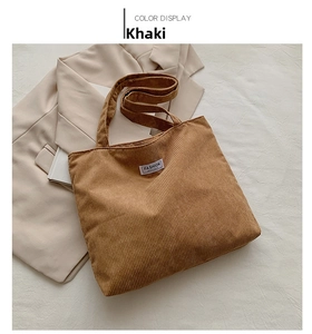 Detail of khaki corduroy tote bag with Fashion Instinct label on textured fabric